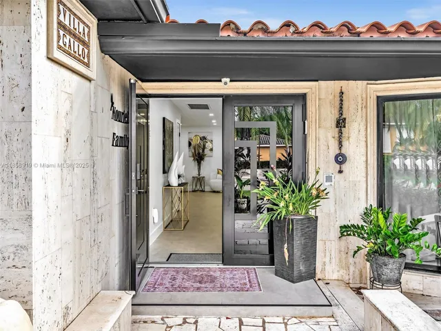 an aerial view of residential houses with outdoor space and swimming pool