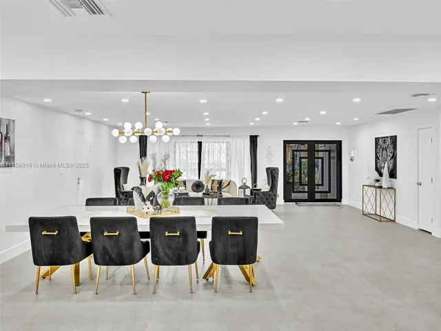 a living room with furniture a dining table and chairs