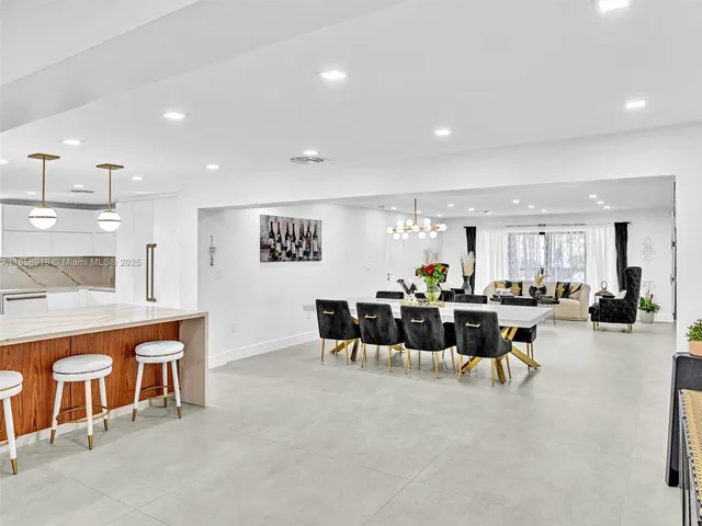 a kitchen with stainless steel appliances granite countertop a sink and a white cabinets