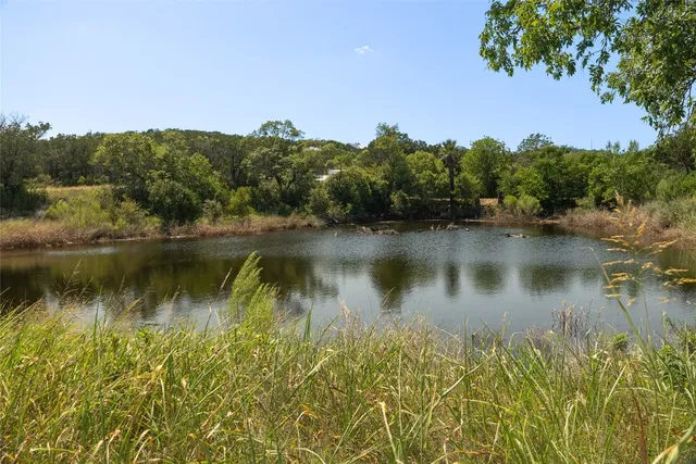 a view of a lake in middle of forest