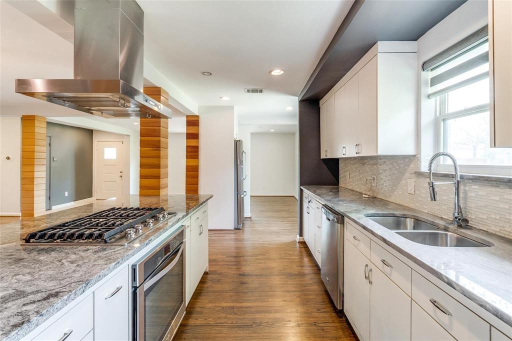 5131 Urban Crest Road Dallas, TX 75227 - Photo 14 of 25 a kitchen with stainless steel appliances granite countertop a sink stove and cabinets