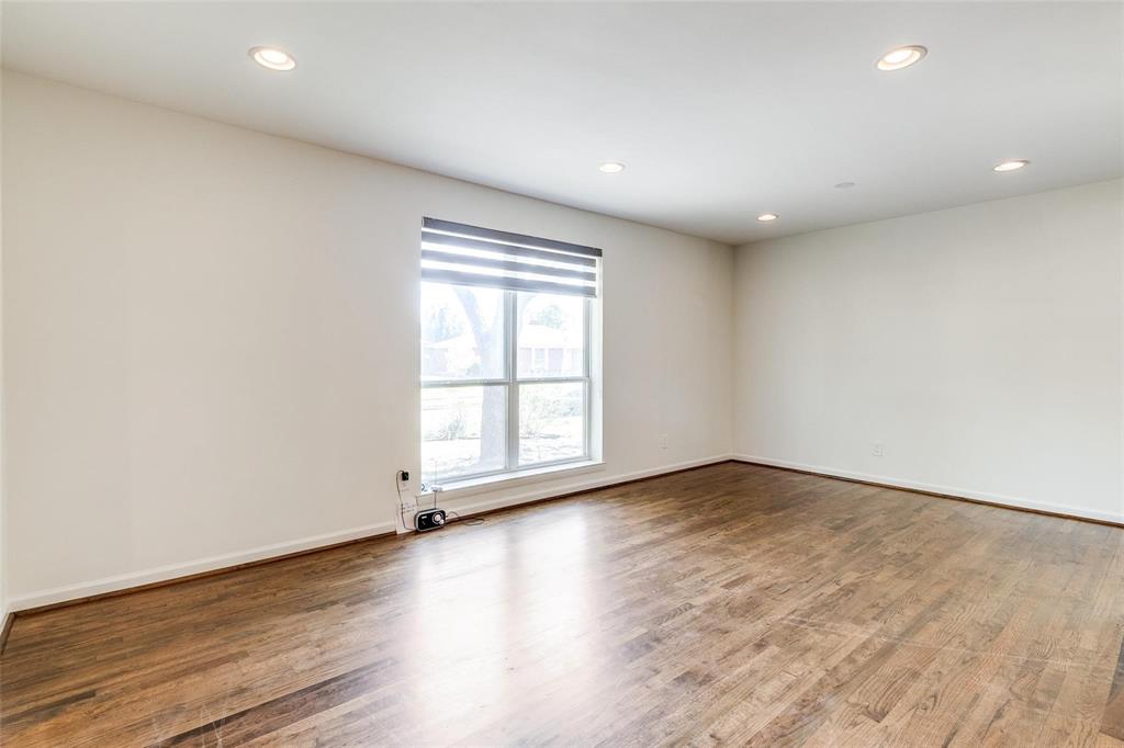 5131 Urban Crest Road Dallas, TX 75227 - Photo 17 of 25 an empty room with wooden floor and windows