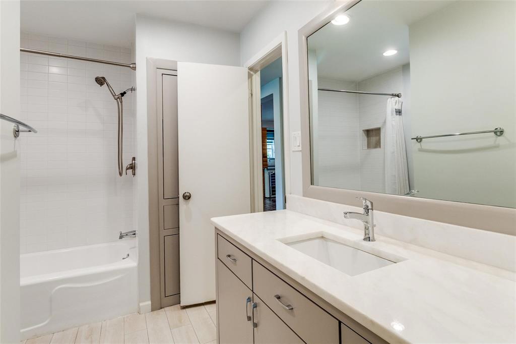 5131 Urban Crest Road Dallas, TX 75227 - Photo 22 of 25 a bathroom with a sink double vanity granite tub shower and a mirror