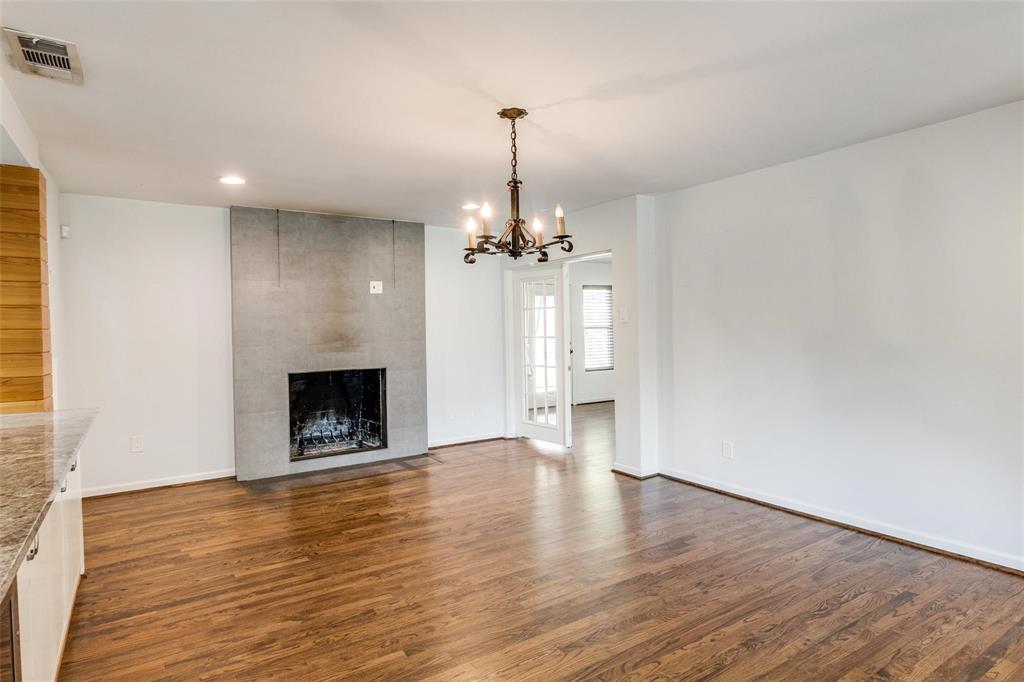 5131 Urban Crest Road Dallas, TX 75227 - Photo 3 of 25 a view of a room with chandelier and a fireplace