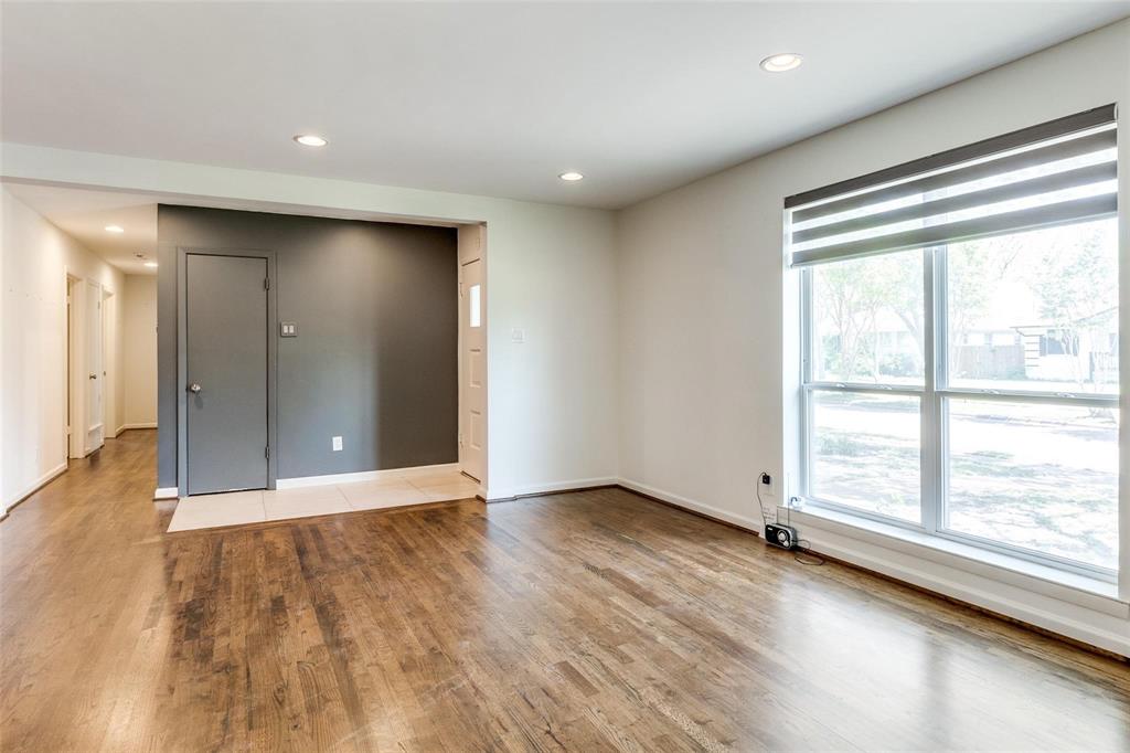 5131 Urban Crest Road Dallas, TX 75227 - Photo 8 of 25 a view of an empty room with wooden floor and a window