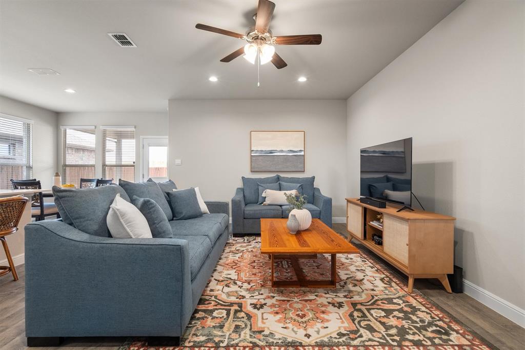 1864 Mensa Drive Haslet, TX 76052 - Photo 8 of 40 a living room with furniture and a flat screen tv