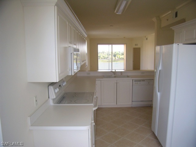8550 Kingbird Loop Fort Myers, FL 33967 - Photo 12 of 16 a view of a kitchen with an empty space and a window