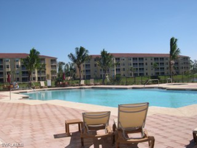 8550 Kingbird Loop Fort Myers, FL 33967 - Photo 2 of 16 a view of swimming pool with outdoor seating and city view