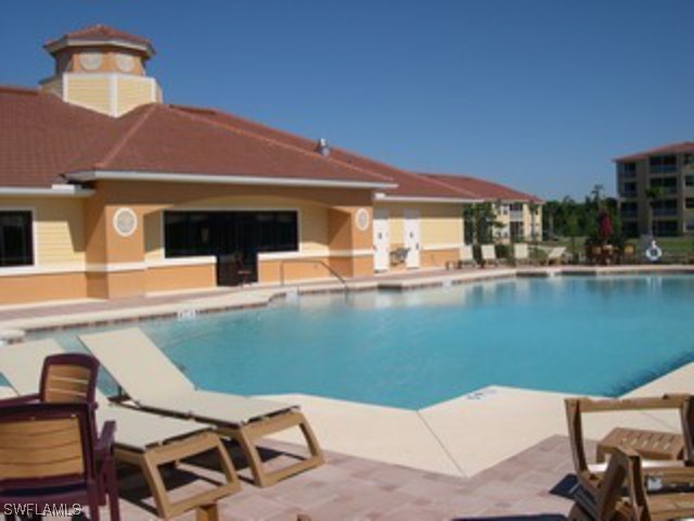 8550 Kingbird Loop Fort Myers, FL 33967 - Photo 3 of 16 a view of a patio with table and chairs near an umbrella