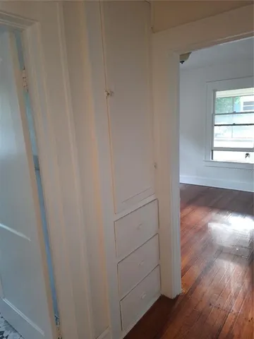 a view of a room with wooden floor