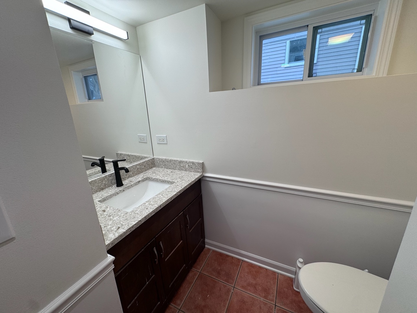 754 Spring Road Elmhurst, IL 60126 - Photo 14 of 32 a bathroom with a sink a toilet a mirror and vanity