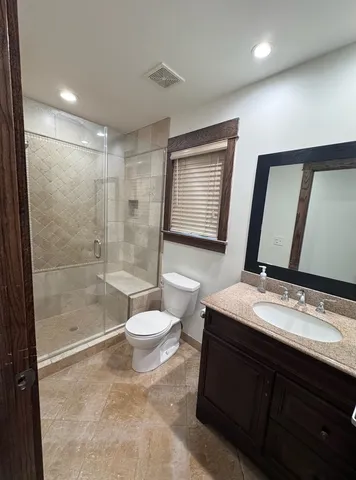 a bathroom with a sink a toilet a mirror and shower