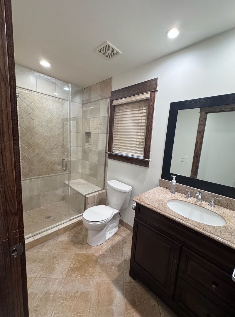 754 Spring Road Elmhurst, IL 60126 - Photo 16 of 32 a bathroom with a sink a toilet a mirror and shower