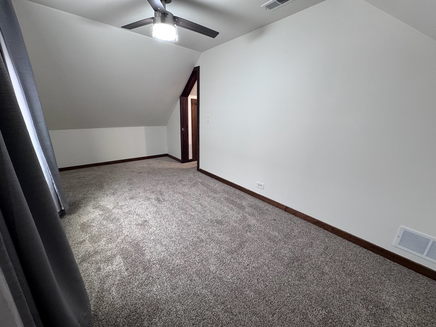 754 Spring Road Elmhurst, IL 60126 - Photo 19 of 32 an empty room with a ceiling fan and carpet
