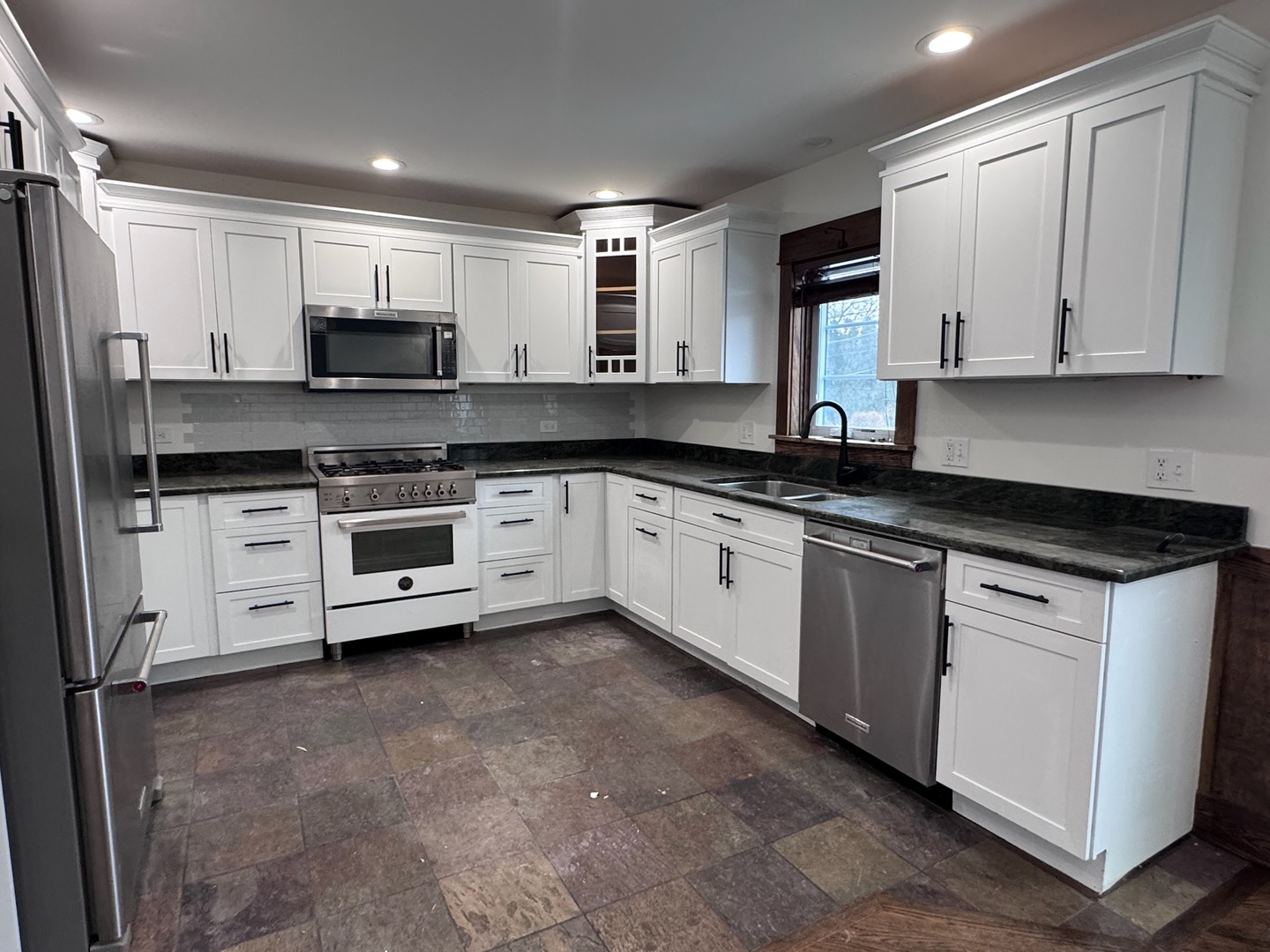 754 Spring Road Elmhurst, IL 60126 - Photo 2 of 32 a kitchen with stainless steel appliances granite countertop a stove sink and cabinets