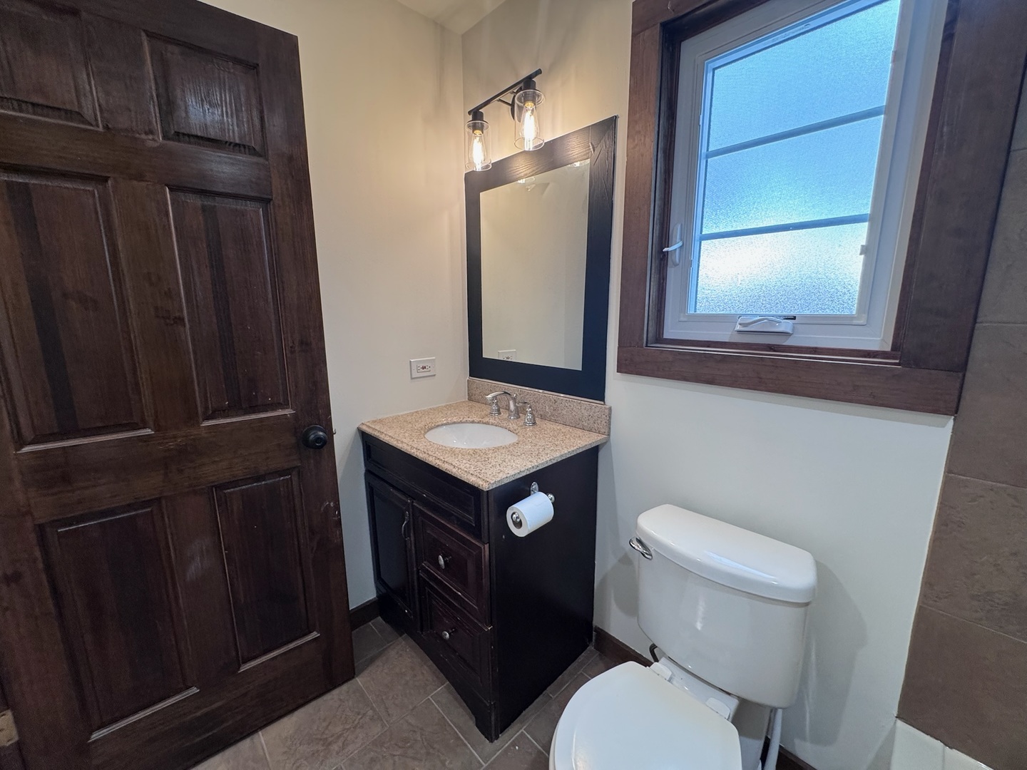 754 Spring Road Elmhurst, IL 60126 - Photo 21 of 32 a bathroom with a toilet a sink and a mirror