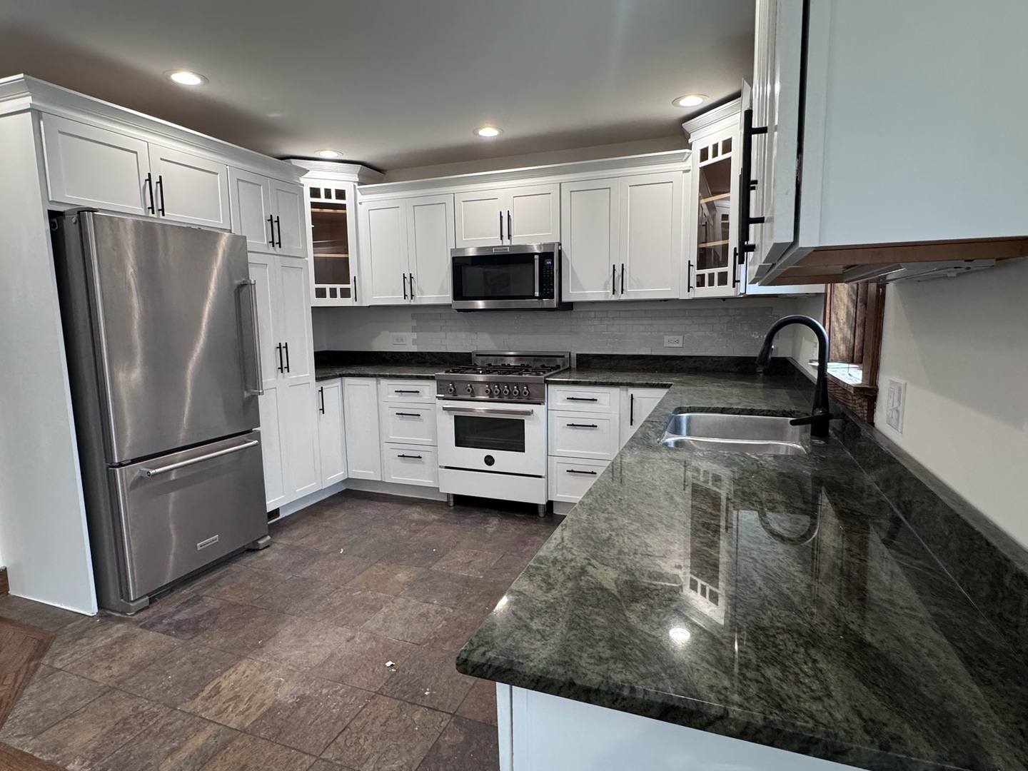 754 Spring Road Elmhurst, IL 60126 - Photo 3 of 32 a kitchen with stainless steel appliances granite countertop a refrigerator a stove and a sink