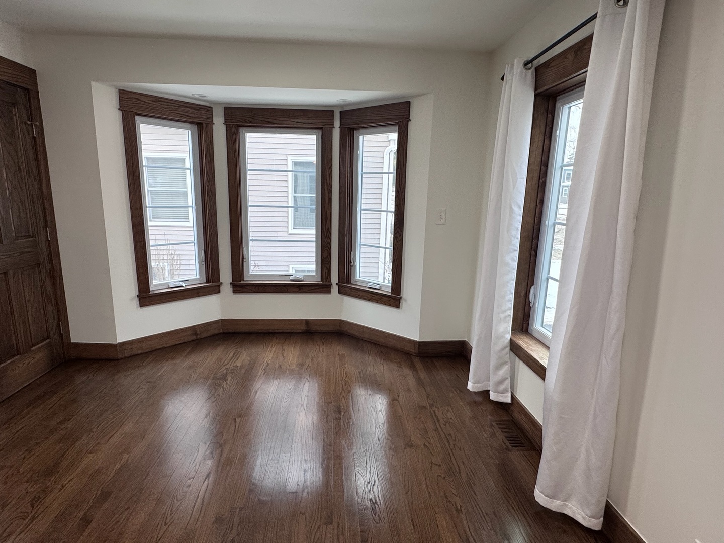 754 Spring Road Elmhurst, IL 60126 - Photo 9 of 32 an empty room with wooden floor and windows