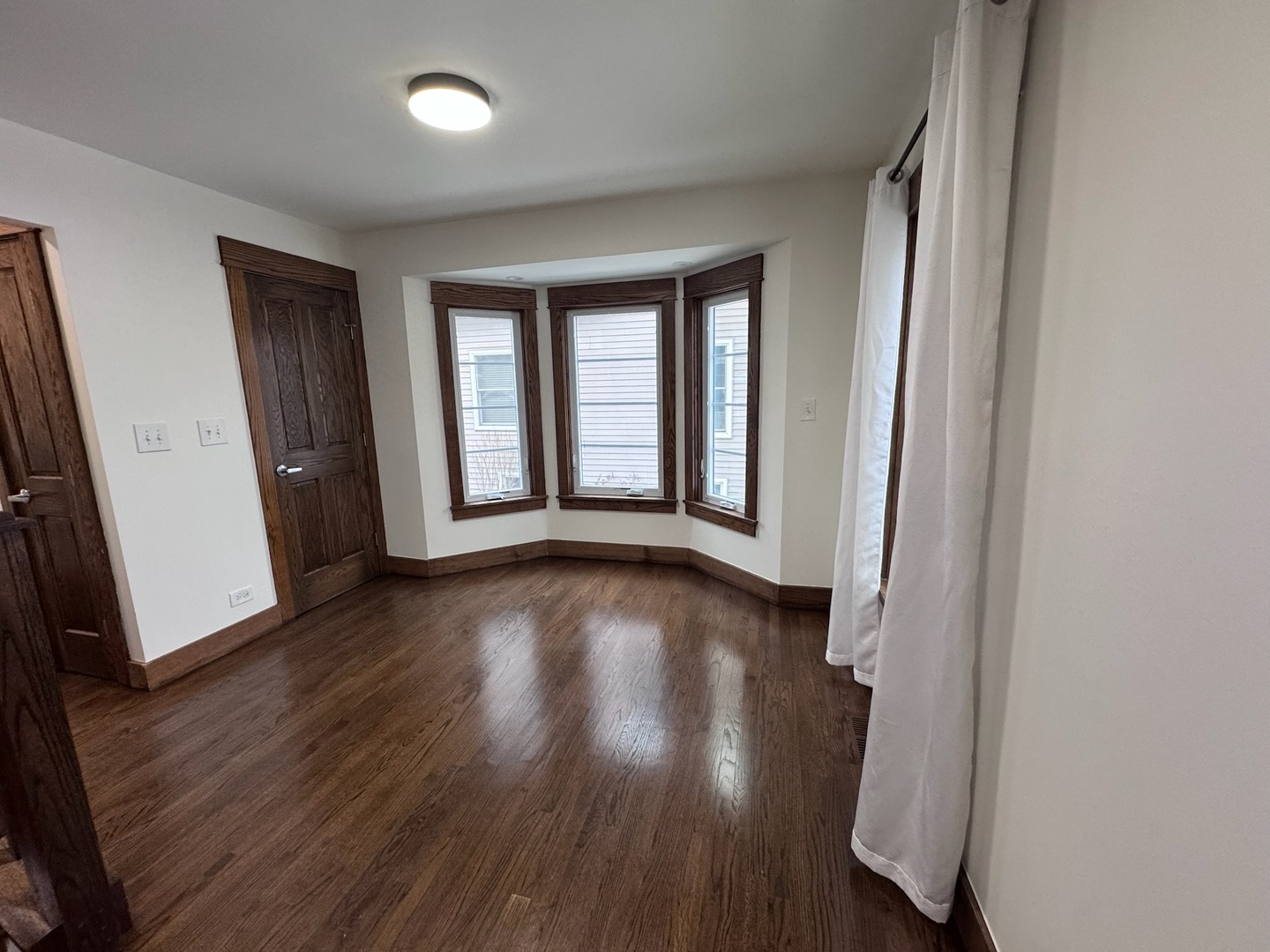 754 Spring Road Elmhurst, IL 60126 - Photo 10 of 32 an empty room with wooden floor and windows