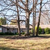 a view of a house with snow on the next to a yard