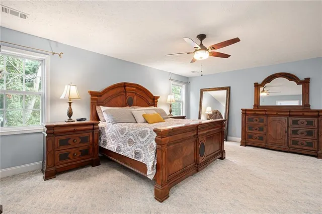 a spacious bathroom with a tub sink and mirror