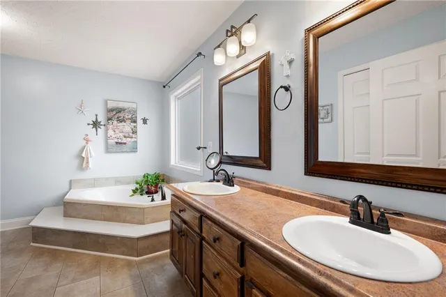 a bedroom with a bed and a flat tv screen on a dresser