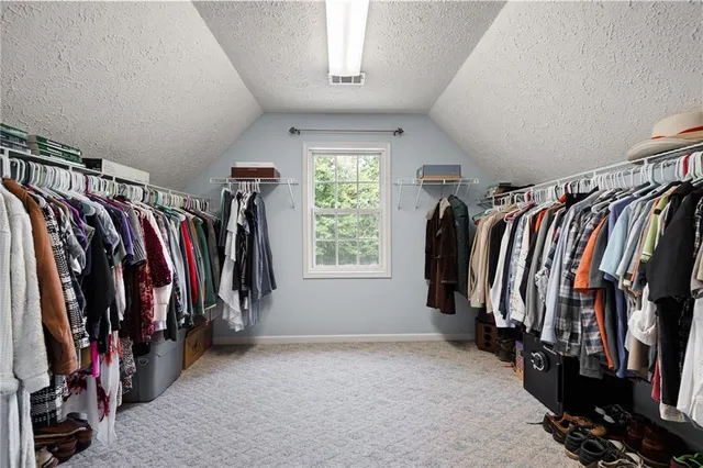 a spacious bedroom with a bed and a couch