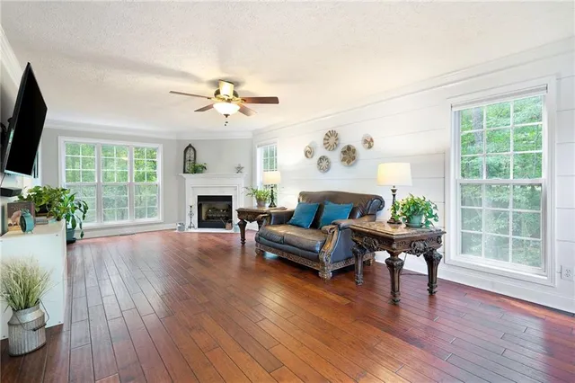 a living room with furniture a fireplace and a flat screen tv
