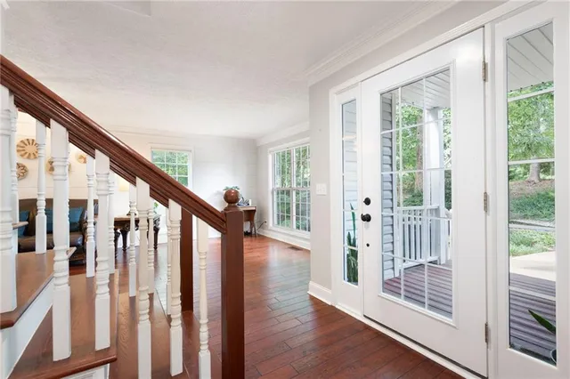 a view of an entryway with wooden floor and stairs