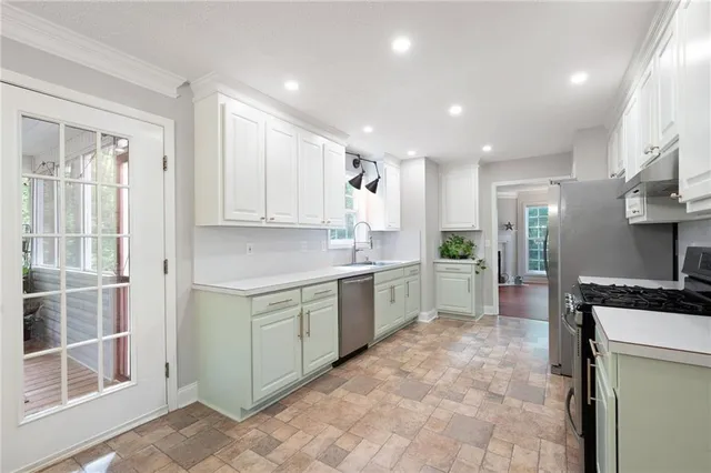 a kitchen with a sink cabinets and stainless steel appliances