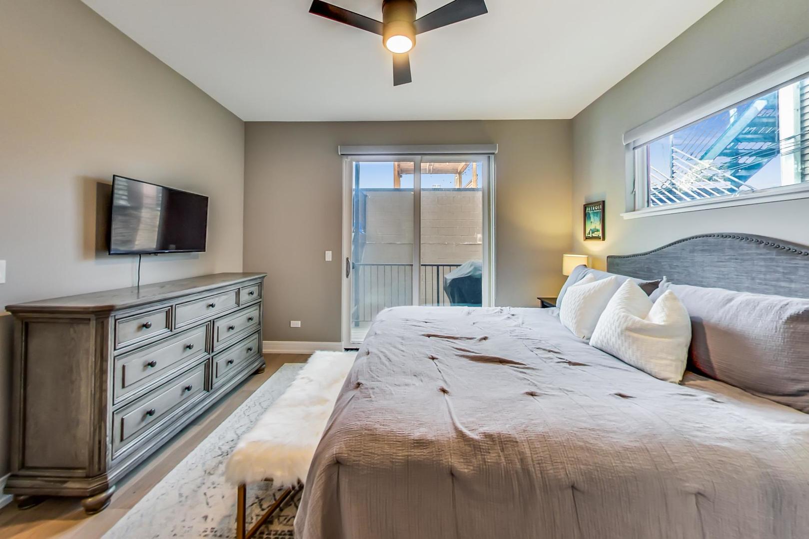 728 North Elizabeth Street, Unit 1 Chicago, IL 60642 - Photo 11 of 27 a bedroom with a bed and a flat screen tv