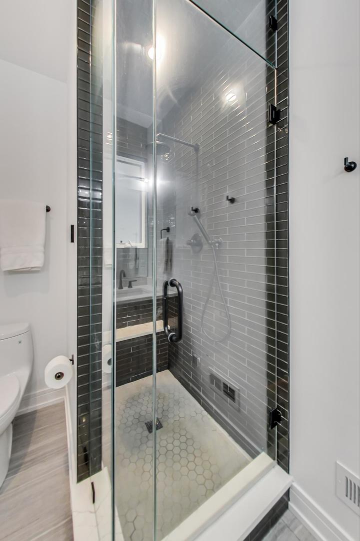 728 North Elizabeth Street, Unit 1 Chicago, IL 60642 - Photo 14 of 27 a bathroom with a shower and a toilet