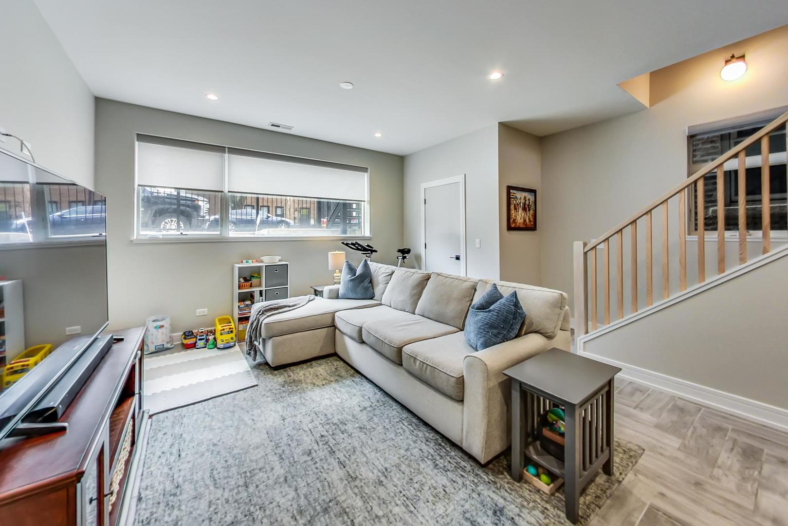 728 North Elizabeth Street, Unit 1 Chicago, IL 60642 - Photo 15 of 27 a living room with furniture and paintings on the wall