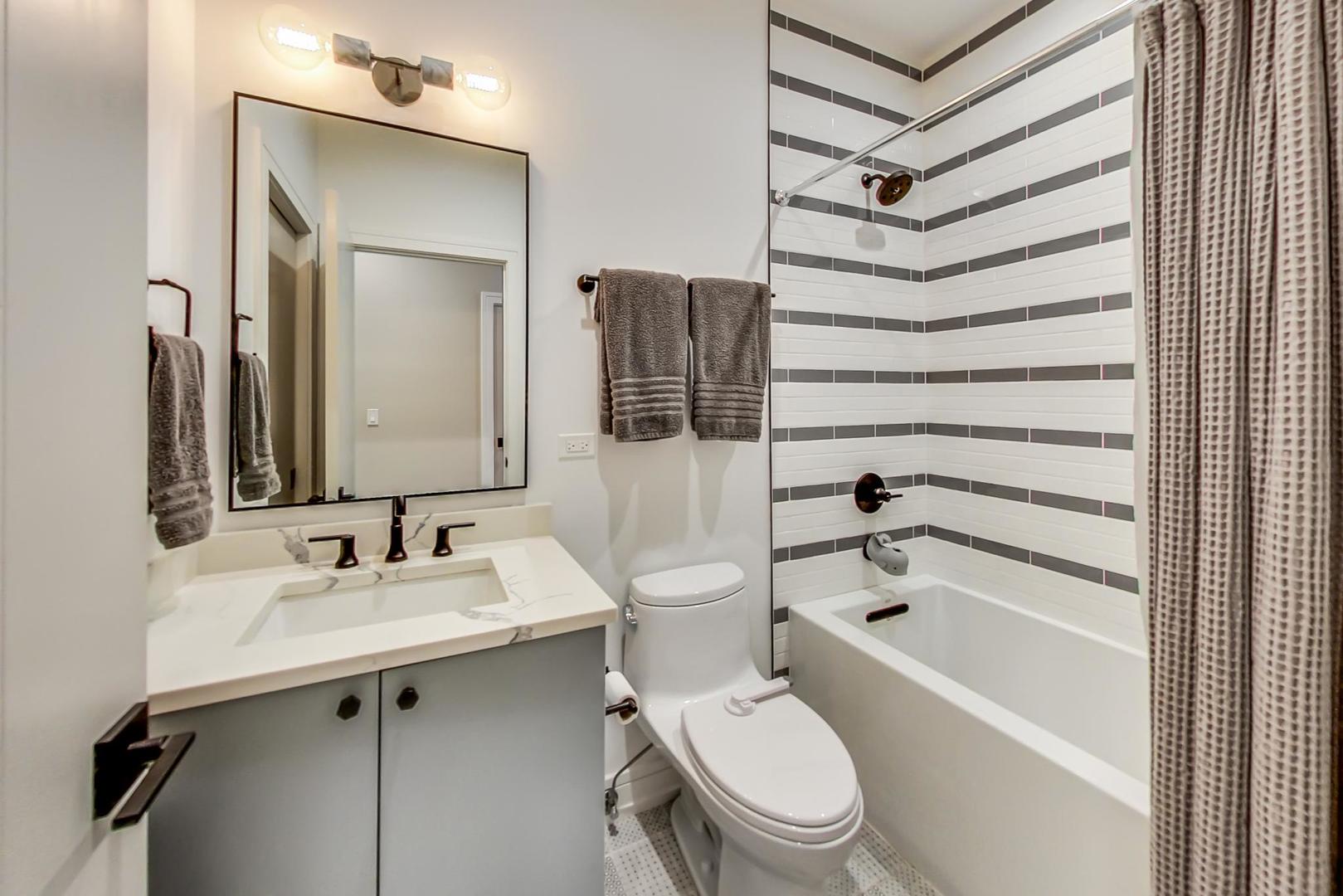 728 North Elizabeth Street, Unit 1 Chicago, IL 60642 - Photo 20 of 27 a bathroom with a sink toilet and shower