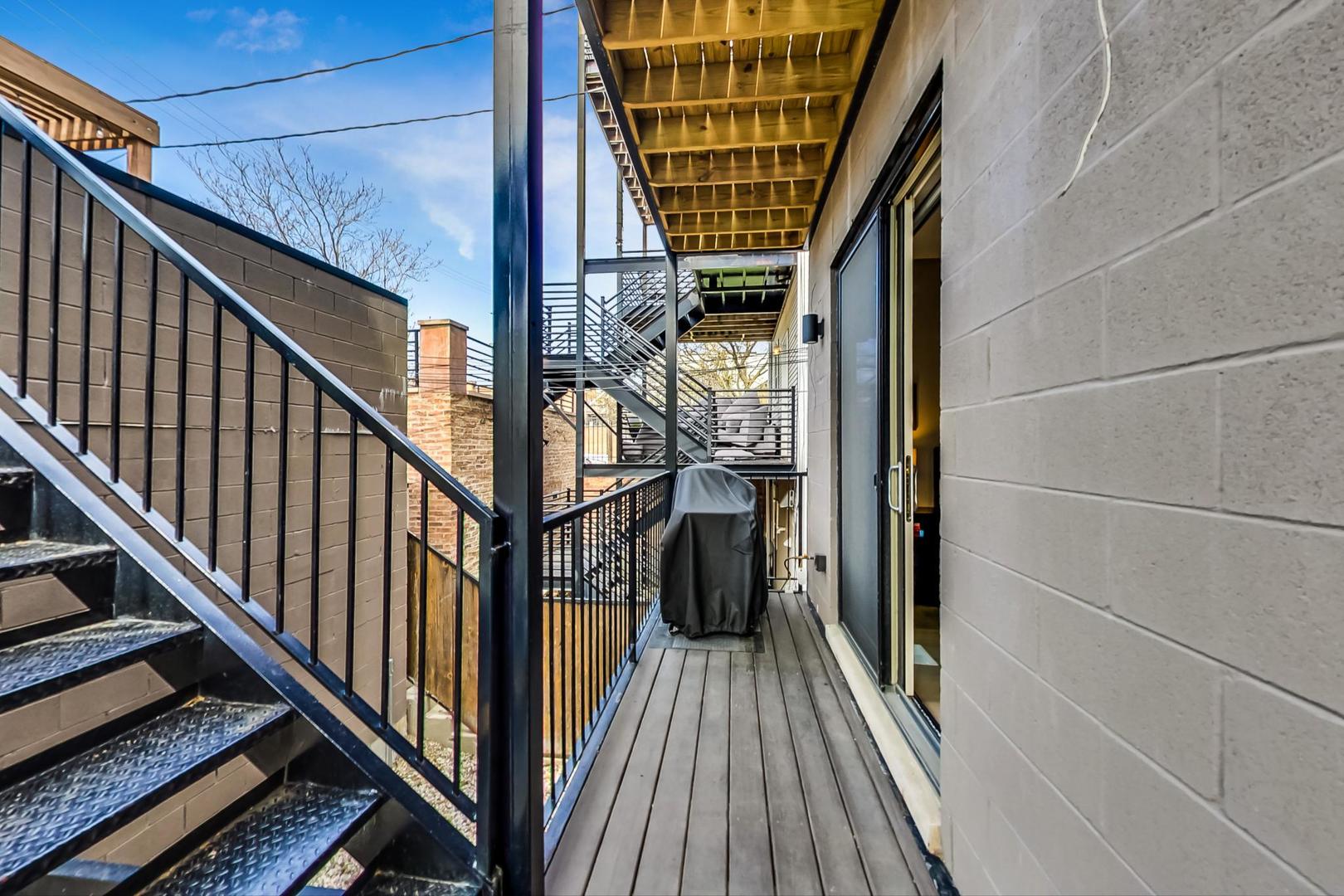 728 North Elizabeth Street, Unit 1 Chicago, IL 60642 - Photo 21 of 27 a view of balcony with wooden floor and fence