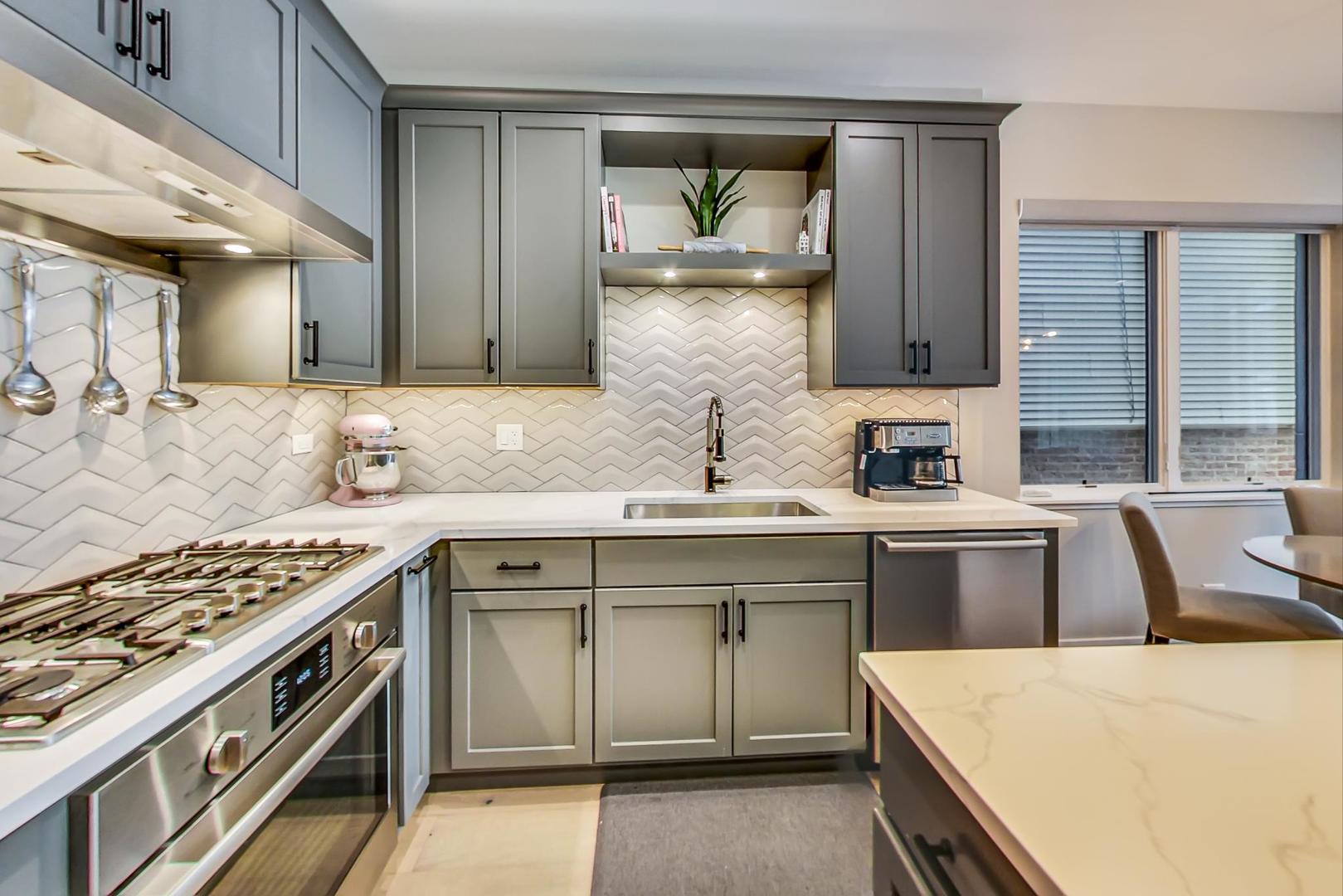 728 North Elizabeth Street, Unit 1 Chicago, IL 60642 - Photo 7 of 27 a kitchen with a sink stove top oven and cabinets