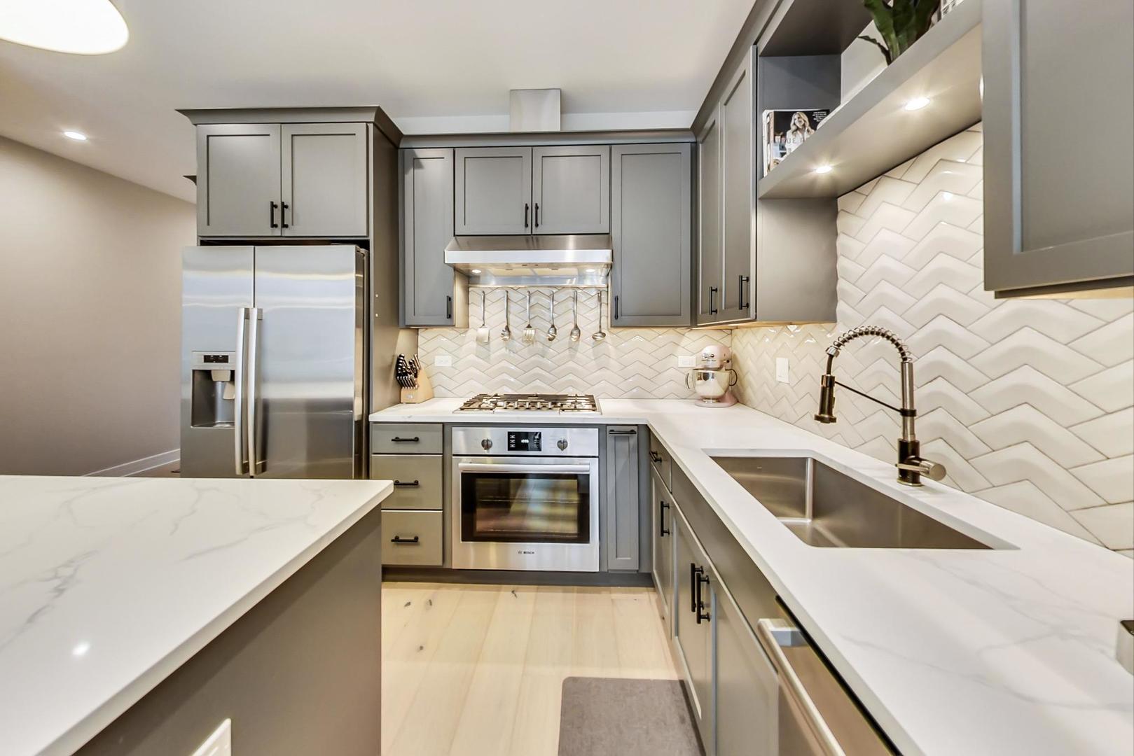 728 North Elizabeth Street, Unit 1 Chicago, IL 60642 - Photo 8 of 27 a kitchen with a stove sink and refrigerator