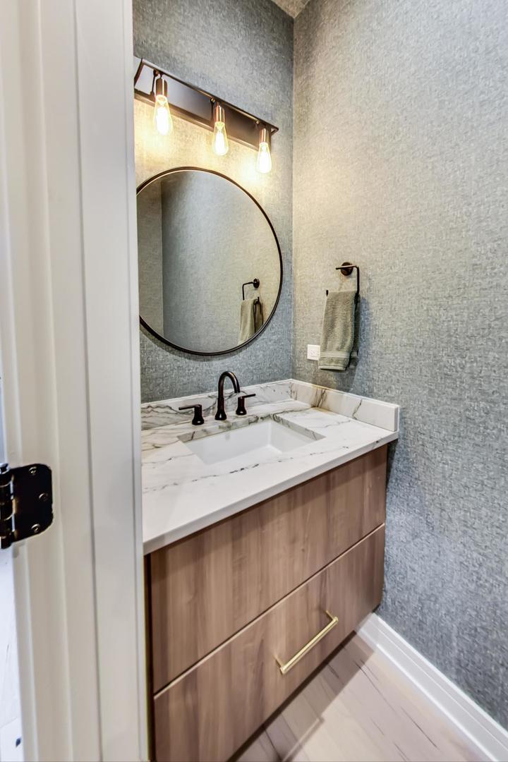 728 North Elizabeth Street, Unit 1 Chicago, IL 60642 - Photo 9 of 27 a bathroom with a sink vanity and a mirror