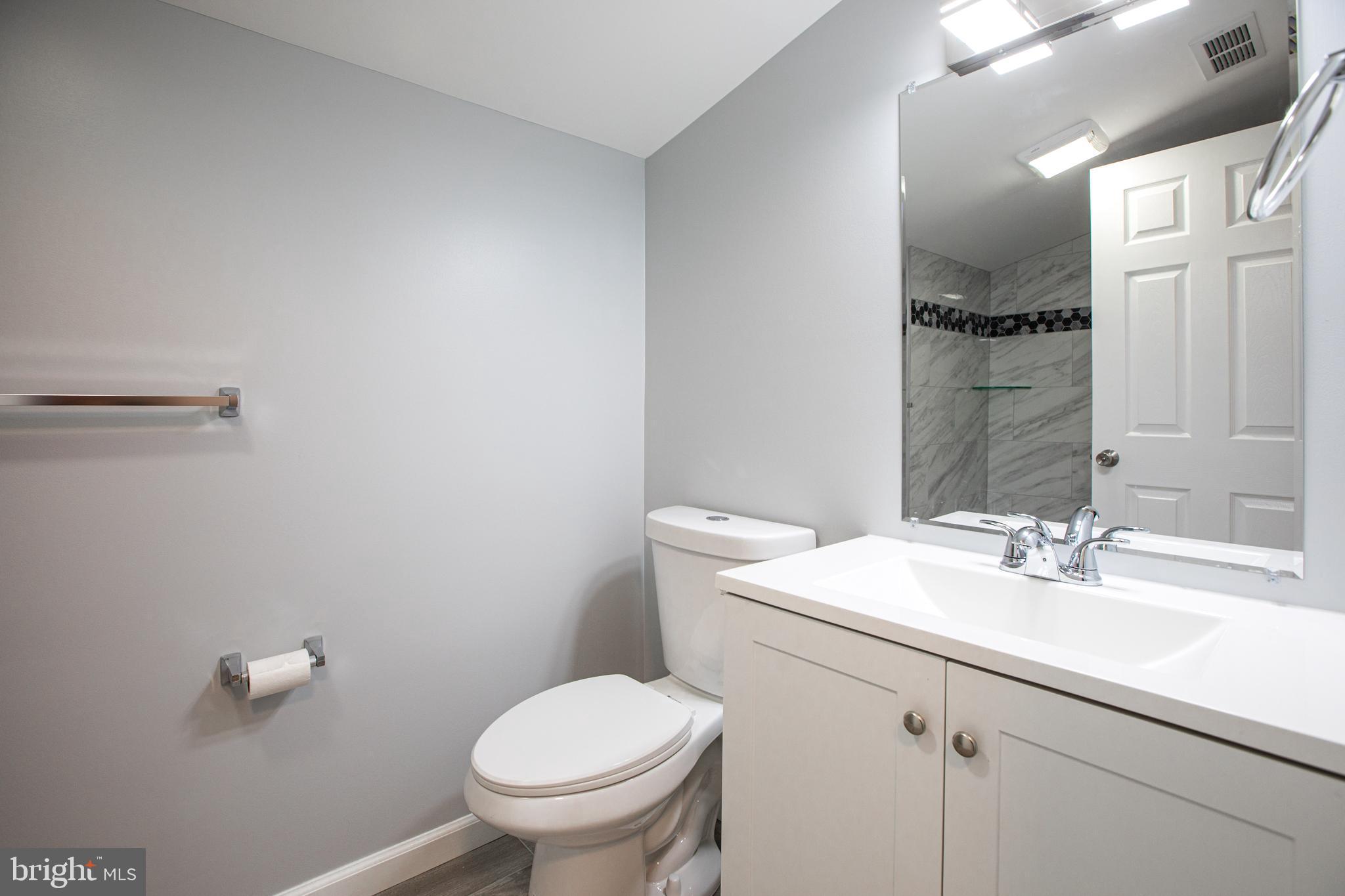 5 Cold Spring Road Hamilton, NJ 08619 - Photo 20 of 33 a bathroom with a sink toilet and mirror