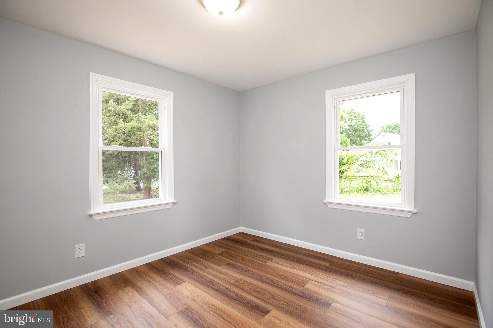 5 Cold Spring Road Hamilton, NJ 08619 - Photo 21 of 33 a view of an empty room with wooden floor and a window