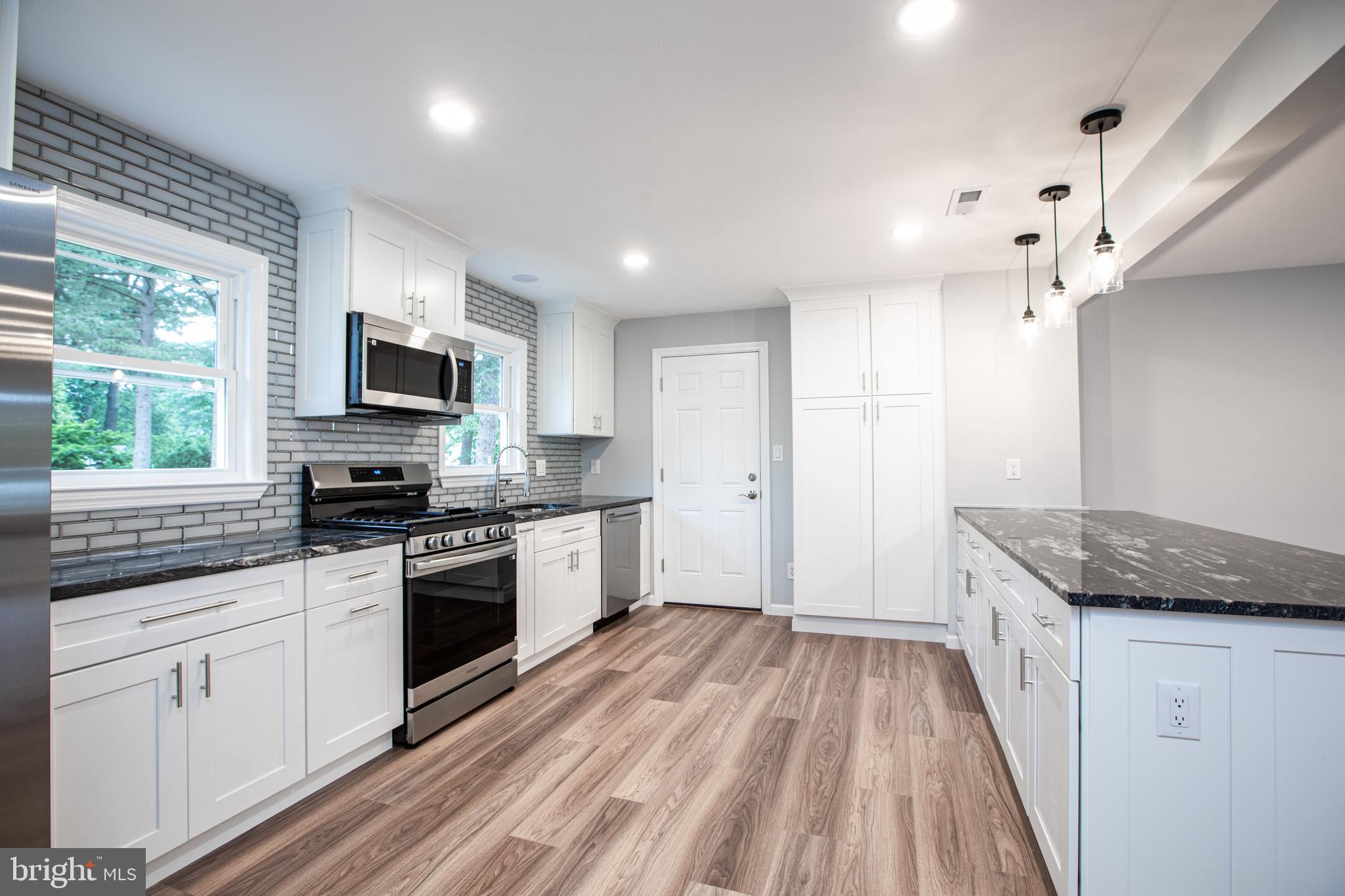 5 Cold Spring Road Hamilton, NJ 08619 - Photo 7 of 33 a kitchen with granite countertop stainless steel appliances a stove sink and microwave