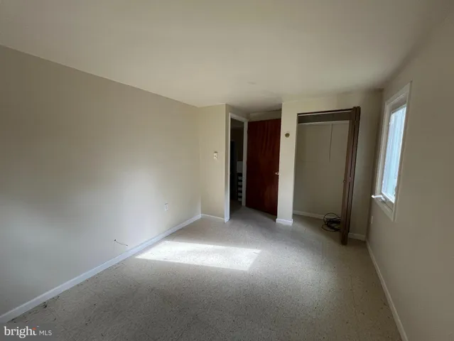 a view of an empty room with a ceiling fan