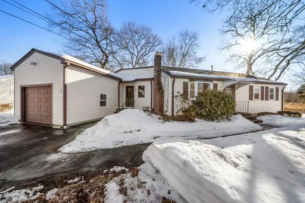 a view of a house with a yard covered in snow
