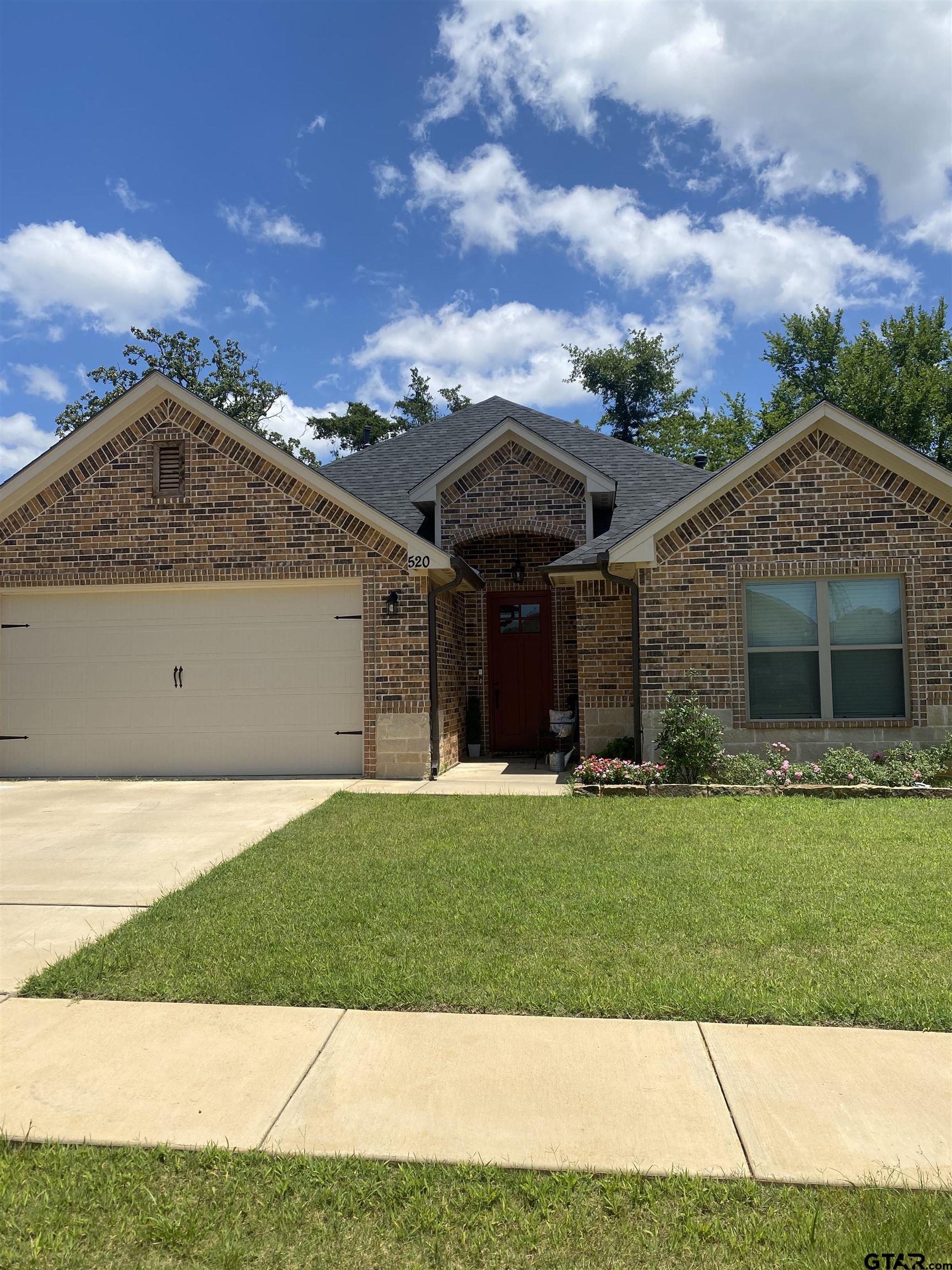 520 Cornerstone Road Lindale, TX 75771 - Photo 1 of 16 a front view of a house with a garden