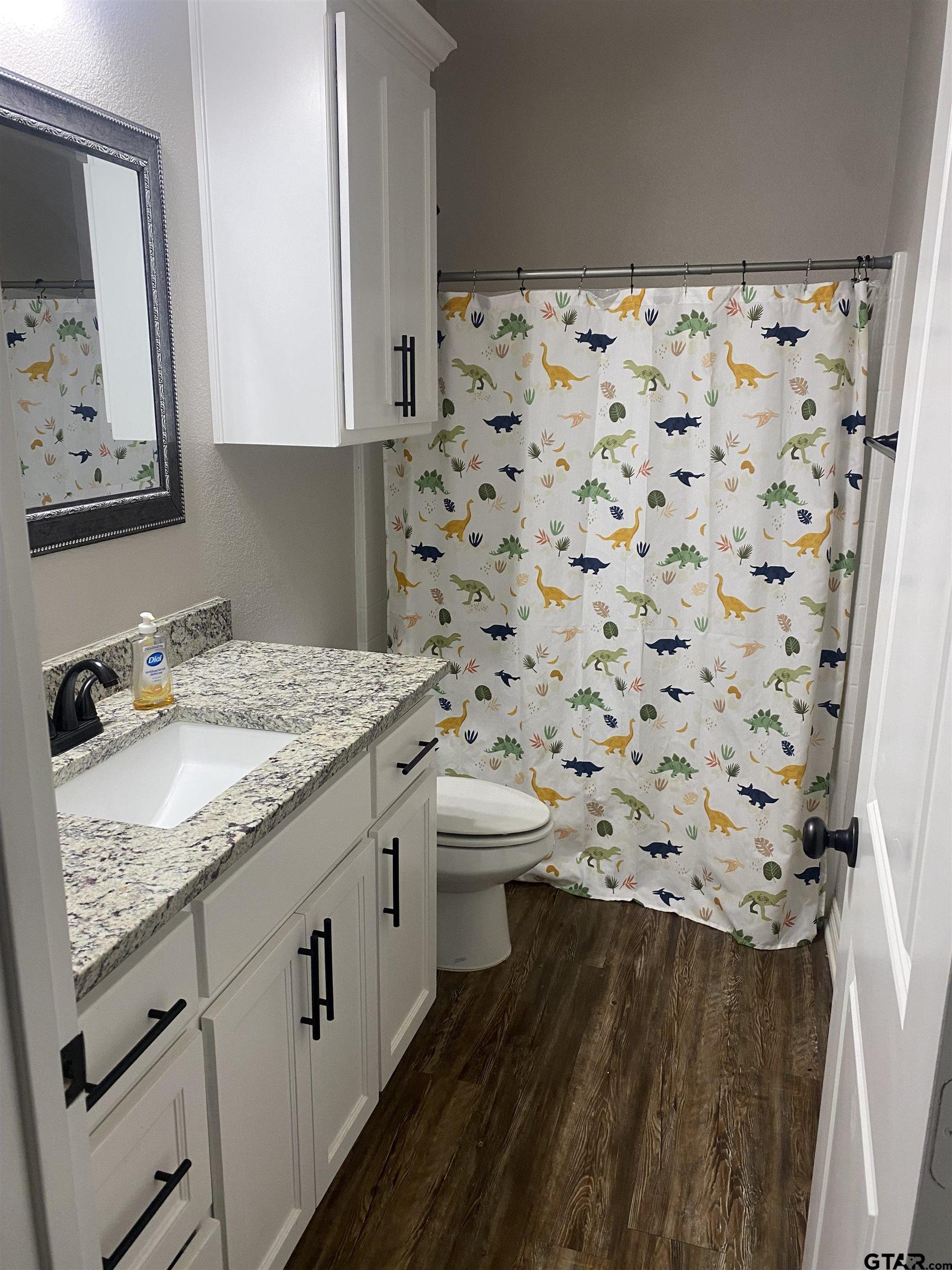 520 Cornerstone Road Lindale, TX 75771 - Photo 16 of 16 a bathroom with a sink toilet and shower