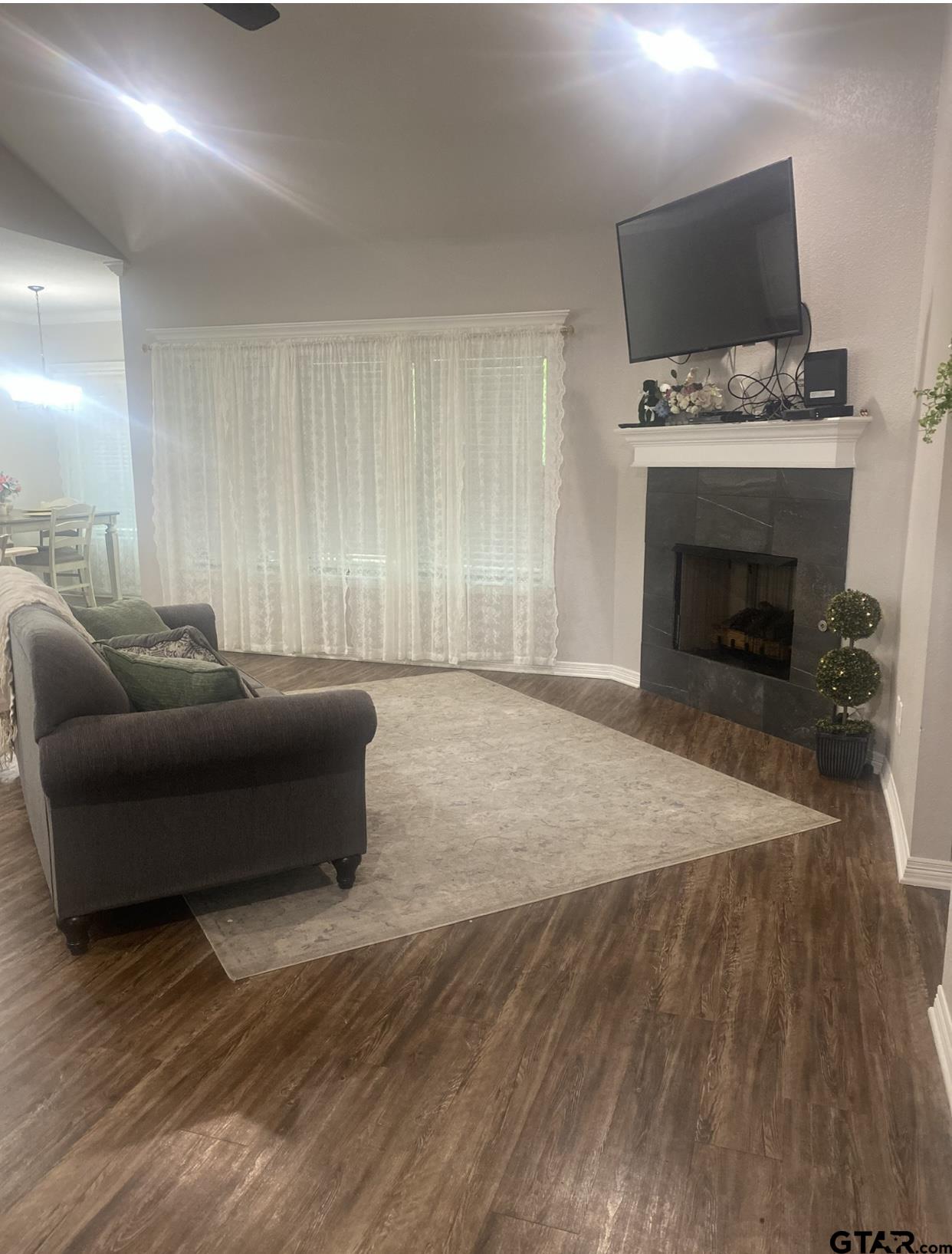 520 Cornerstone Road Lindale, TX 75771 - Photo 5 of 16 a living room with a couch and a fireplace