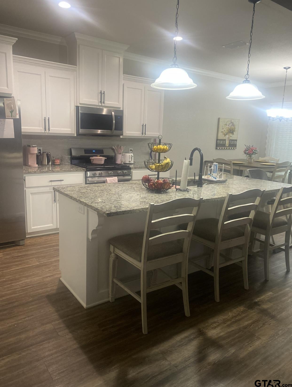 520 Cornerstone Road Lindale, TX 75771 - Photo 6 of 16 a kitchen with appliances a sink and cabinets