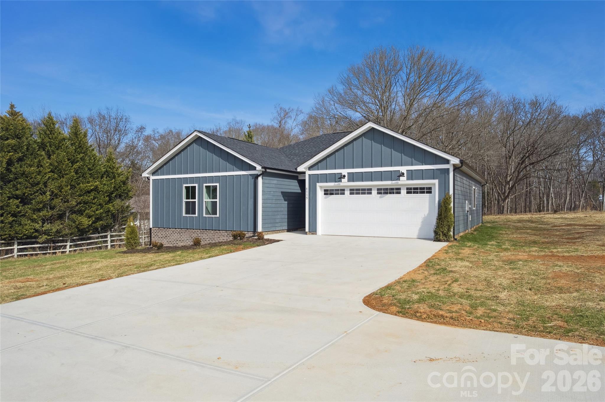 6115 Morehead Road Harrisburg, NC 28075 - Photo 4 of 38 a front view of a house with a yard and garage