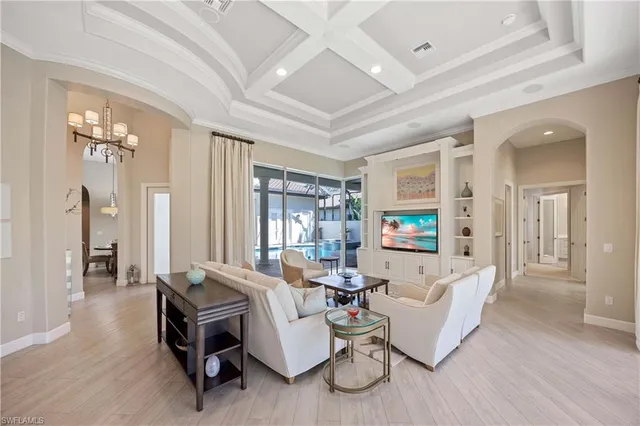 a large white kitchen with a large window a sink and stainless steel appliances
