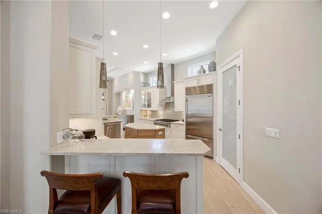 a white stove top oven sitting inside of a kitchen